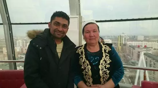 Traveler taking a selfie with the panoramic view from Bayterek Tower, one of Nur-Sultan's best photo attractions.